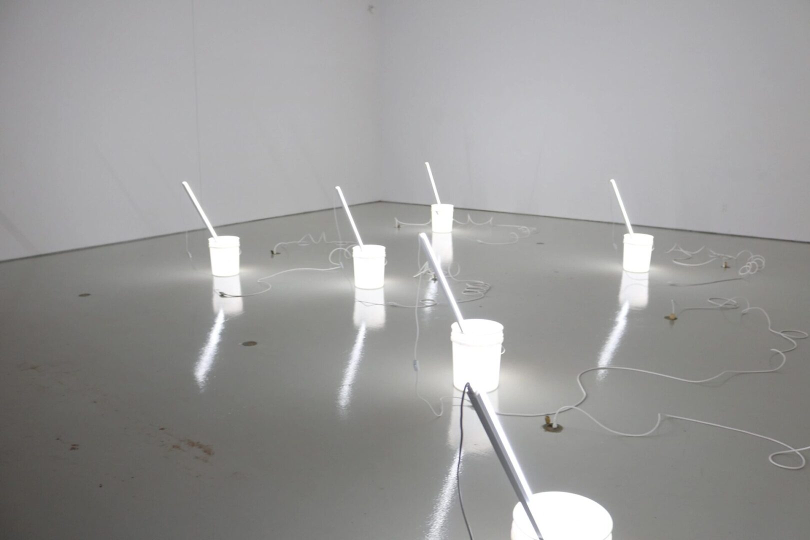 A group of white cups on the floor.