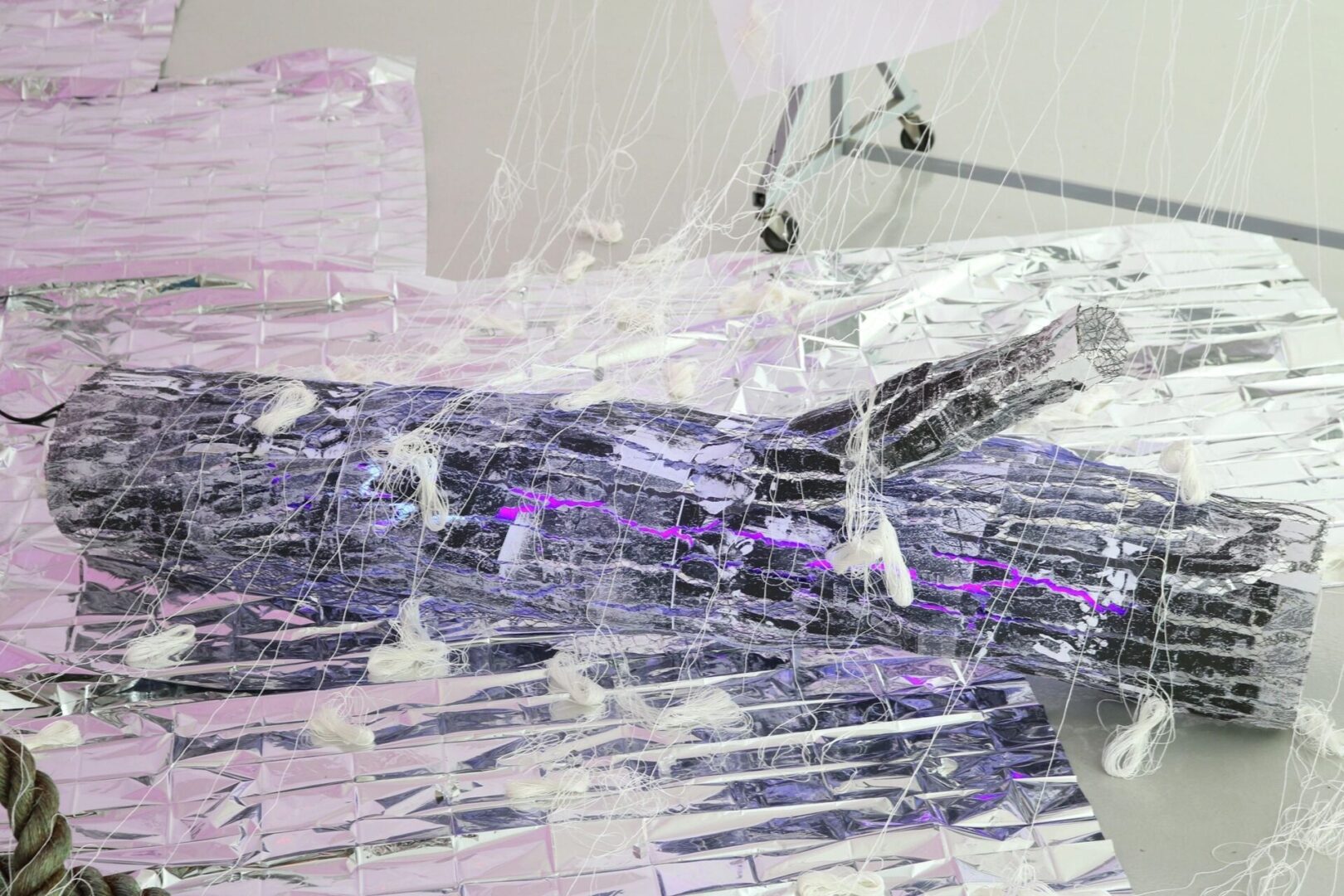 A purple and white abstract painting with a broken glass background.