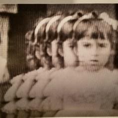 A young girl with long hair and pigtails.