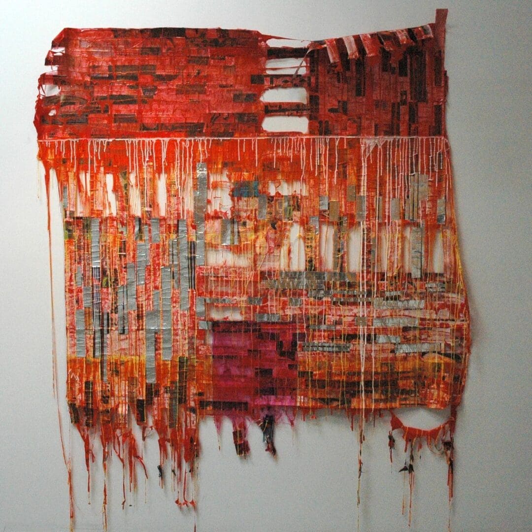 A painting of red and orange paint dripping down the side of a wall.